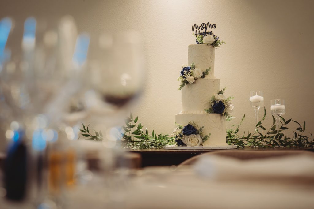 Elegant wedding cake with floral decorations.