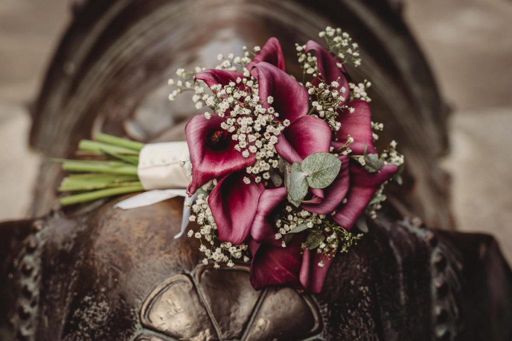Purple calla lilies bouquet with baby's breath flowers.