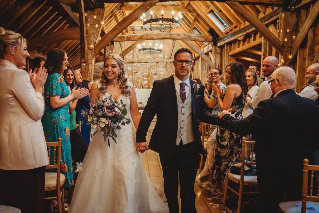 Bride and groom exit ceremony to applause