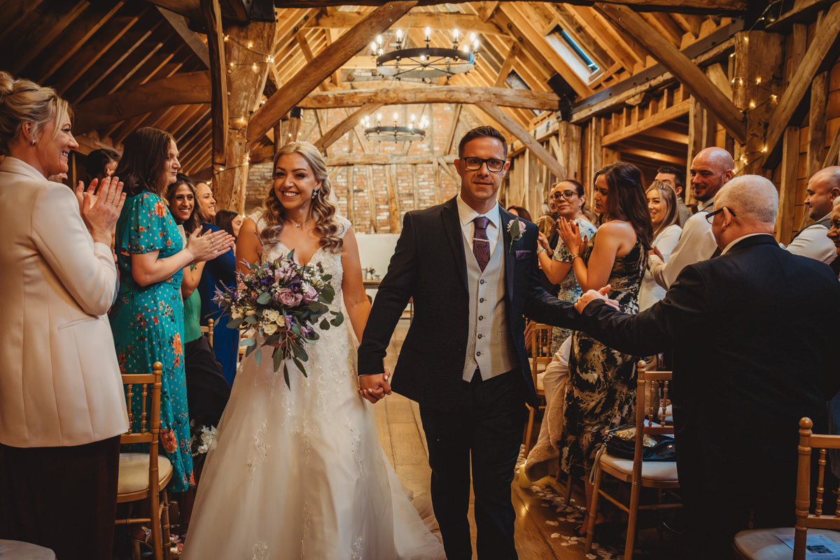 Bride and groom exit ceremony to applause