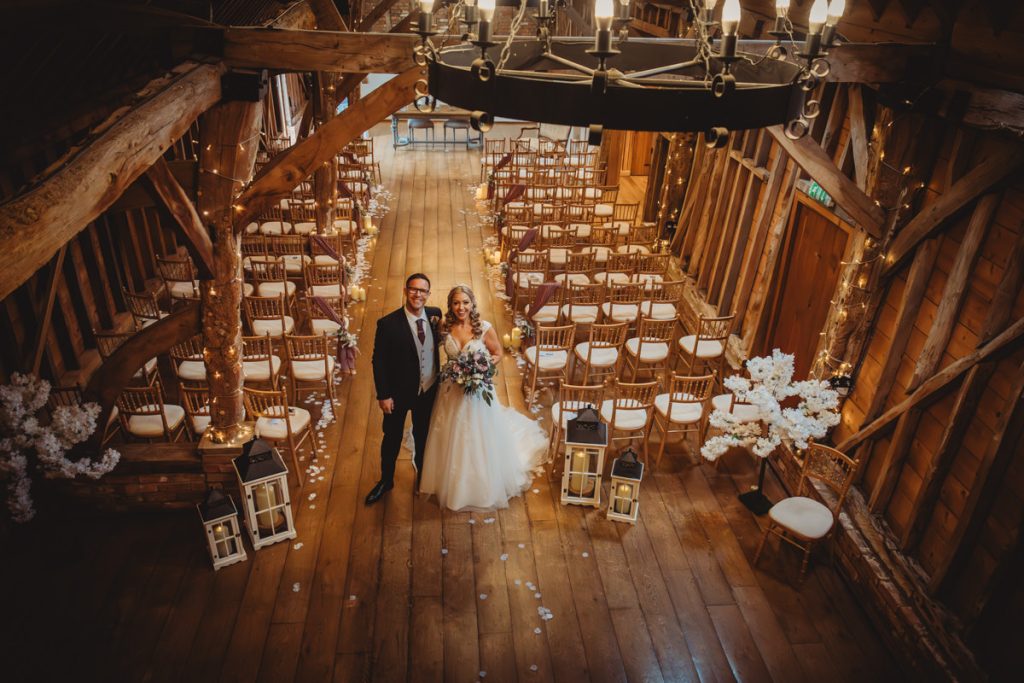 Bride and groom in rustic wedding venue.
