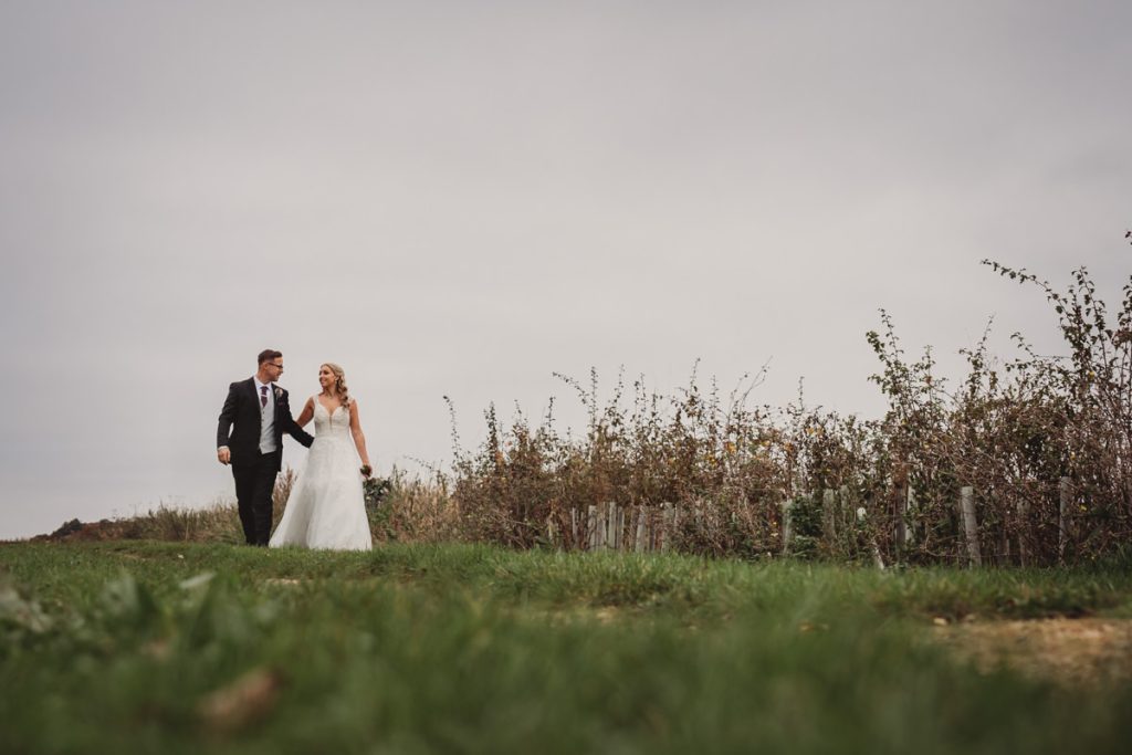 Wedding couple walking in scenic countryside