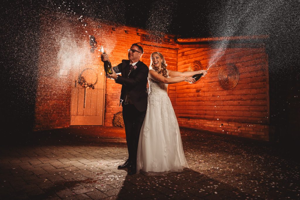 Bride and groom celebrating with champagne.