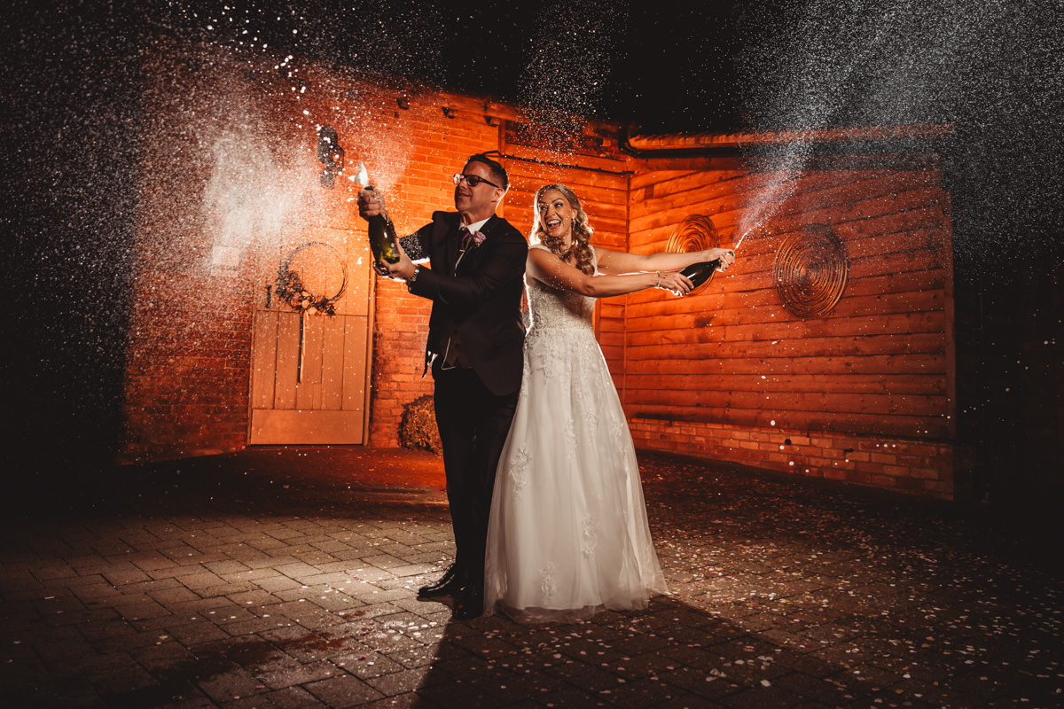 Bride and groom celebrating with champagne.