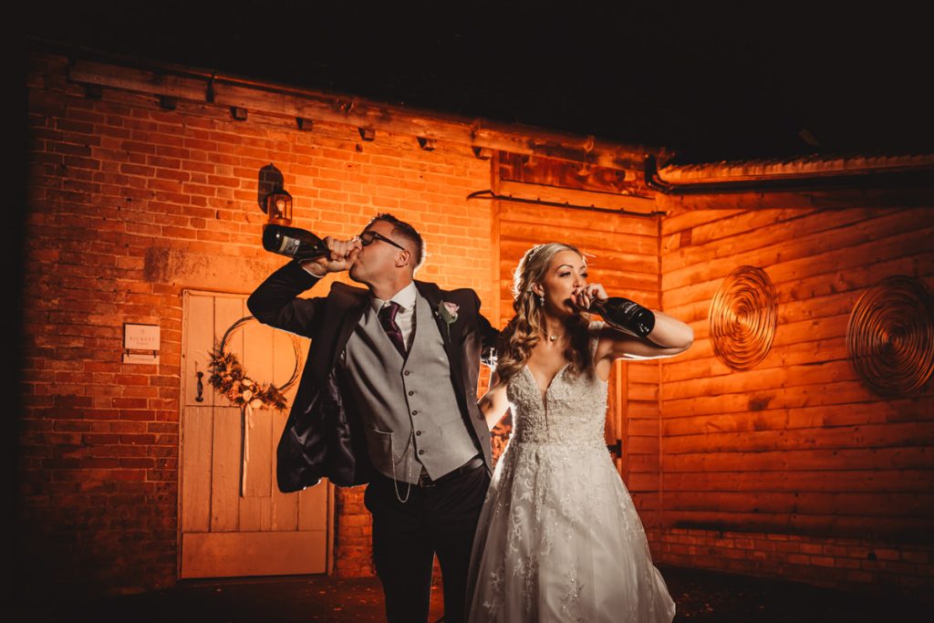 Couple drinking champagne at wedding celebration.