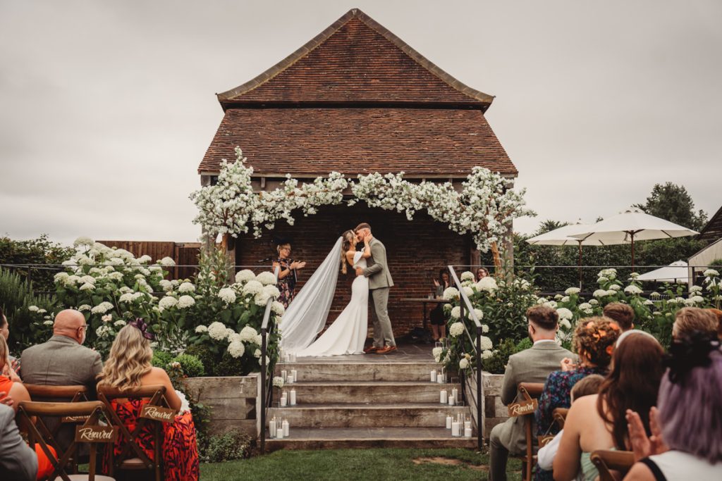 Wedding ceremony kiss in garden setting
