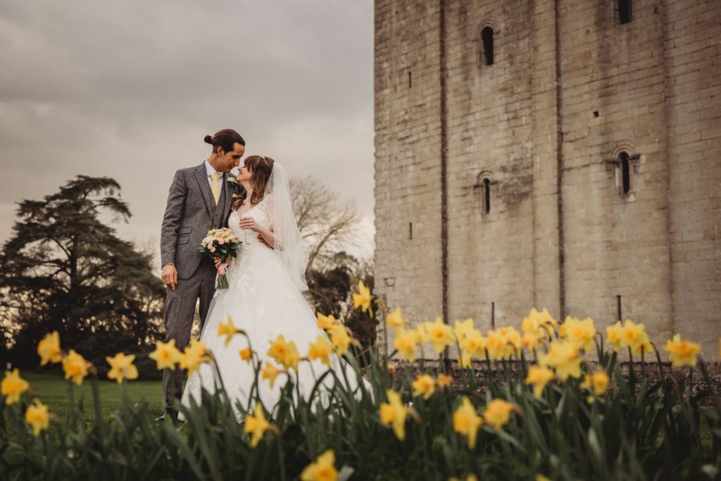 Wedding couple with castle and daffodils background