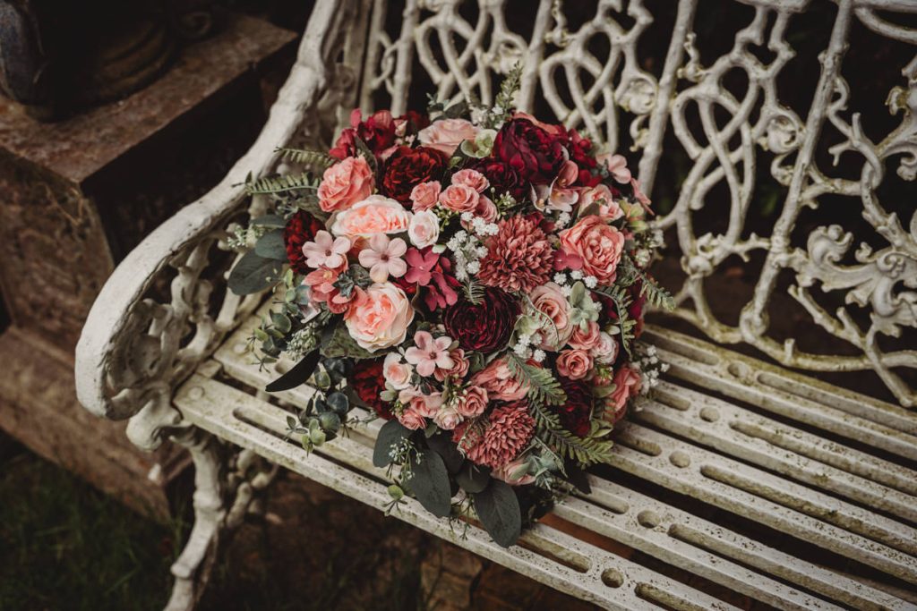 Floral bouquet on ornate garden bench