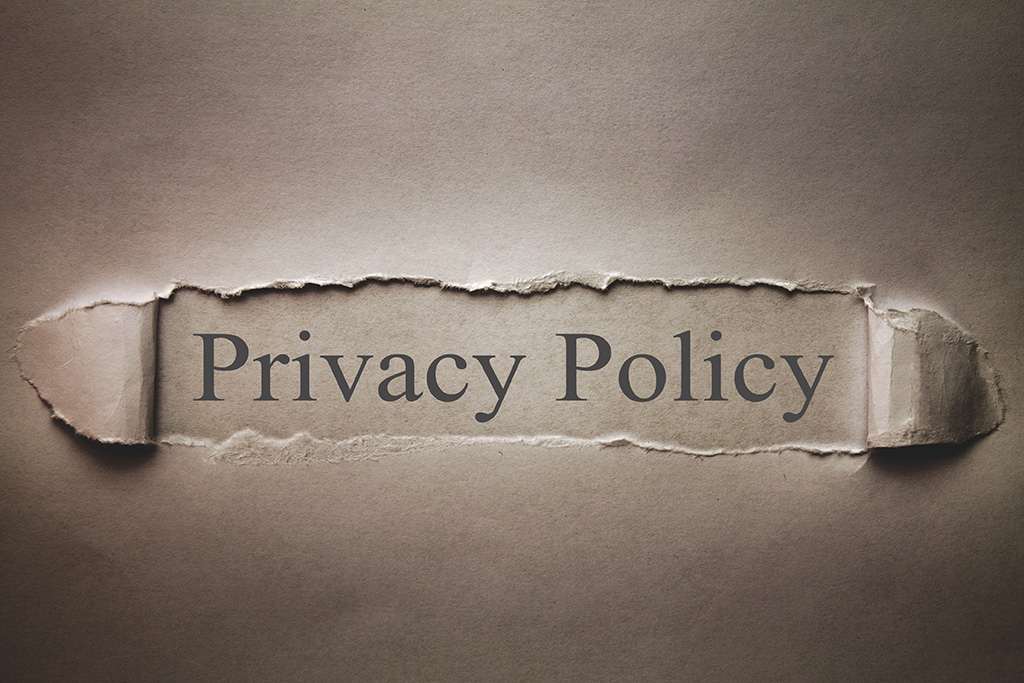 Torn paper revealing 'Privacy Policy' text.