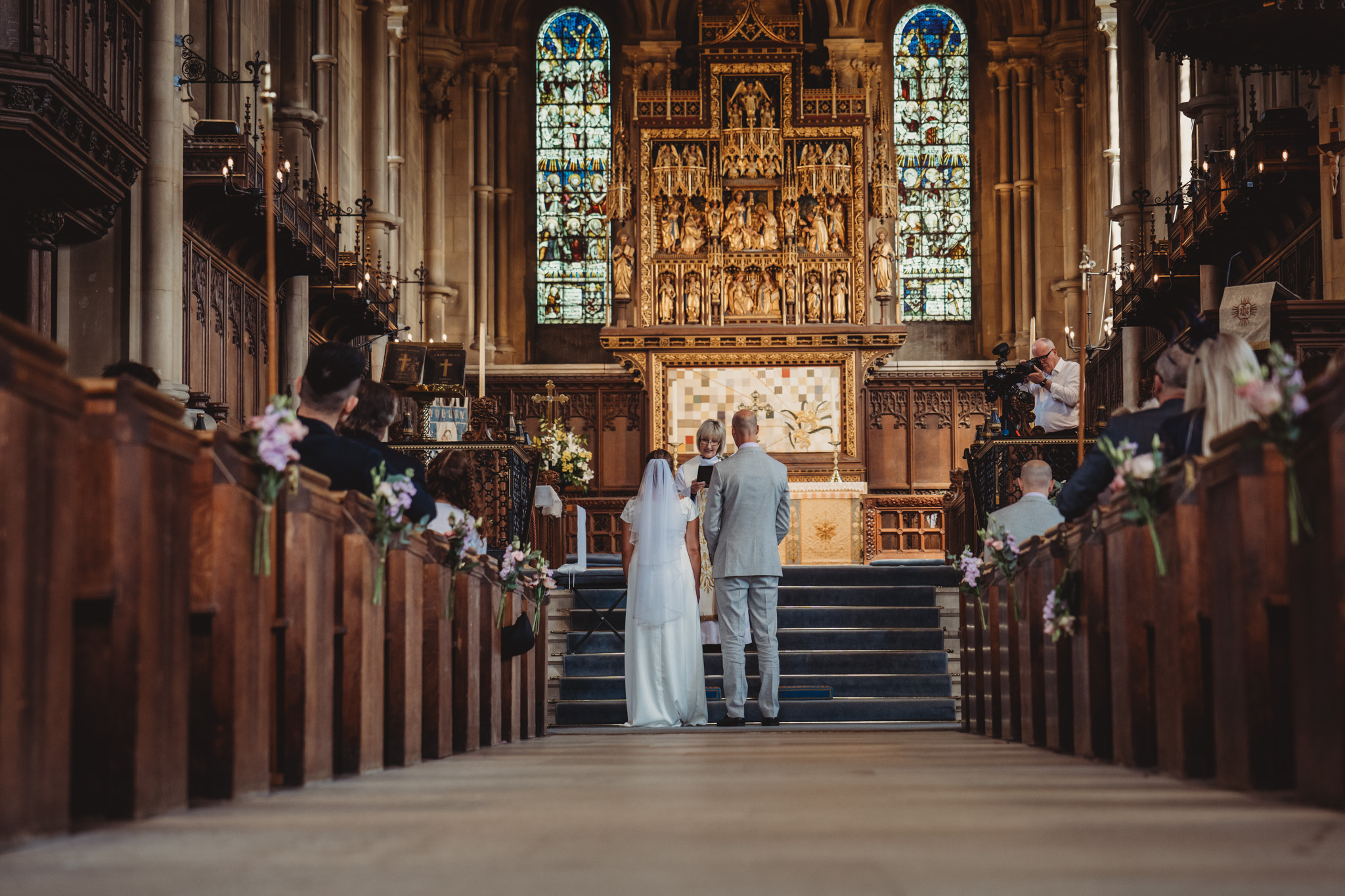 Bride and groom standing at church altar.
