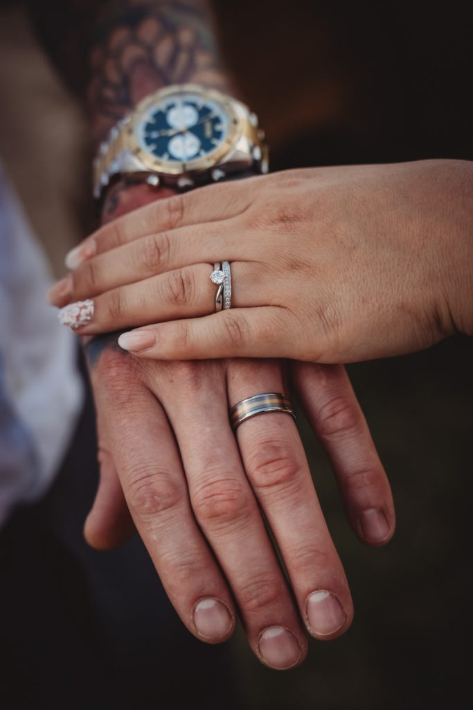 Close-up of couple's hands with wedding rings