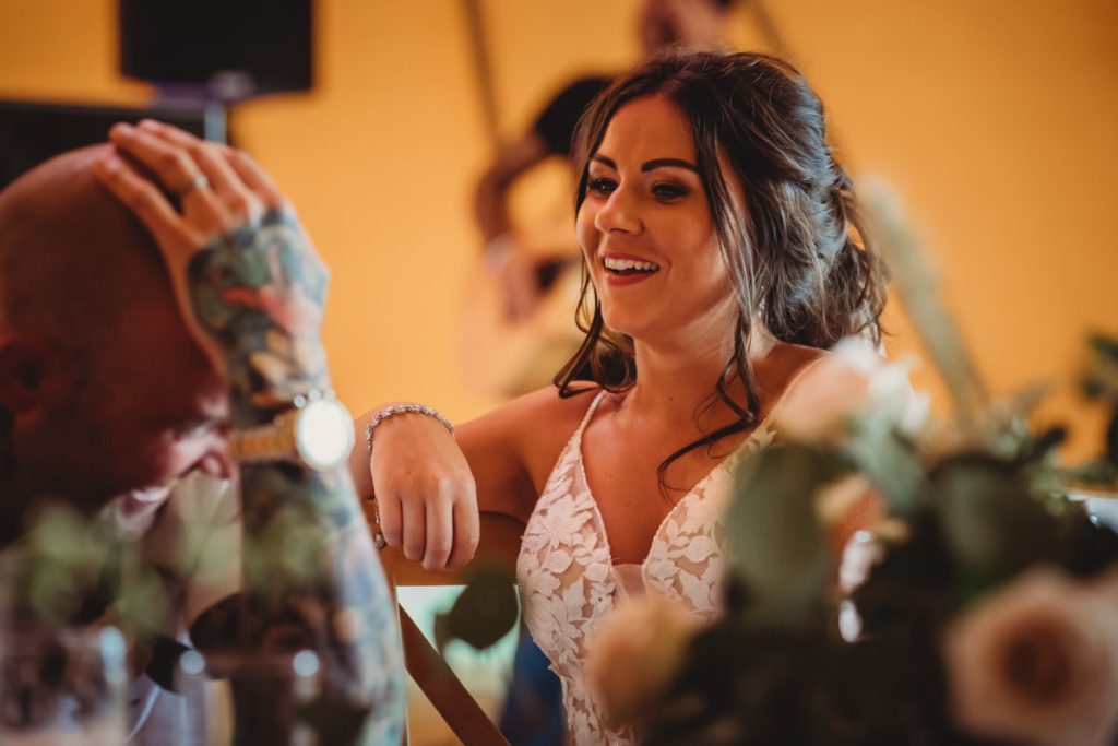 Smiling woman at lively wedding gathering