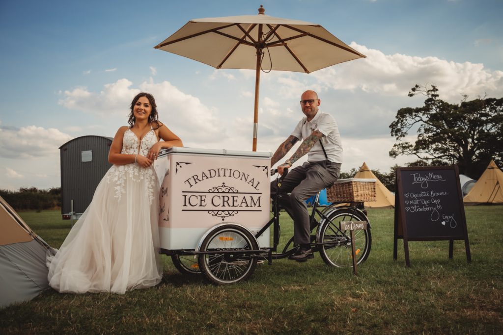 Bride and groom with ice cream tricycle.