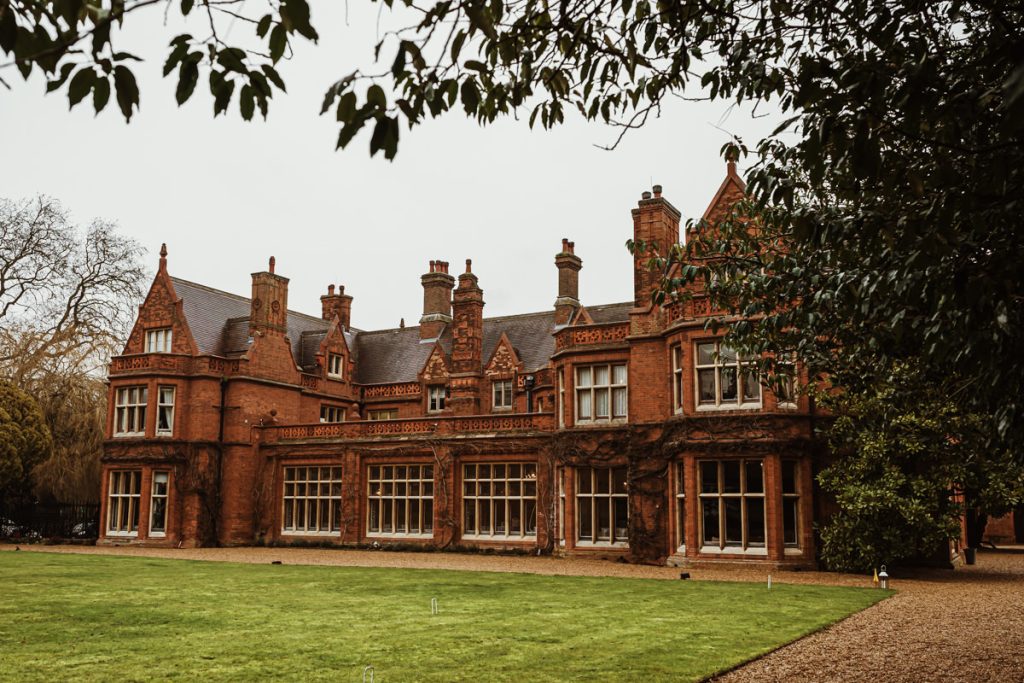 Victorian mansion with ivy-covered brick facade