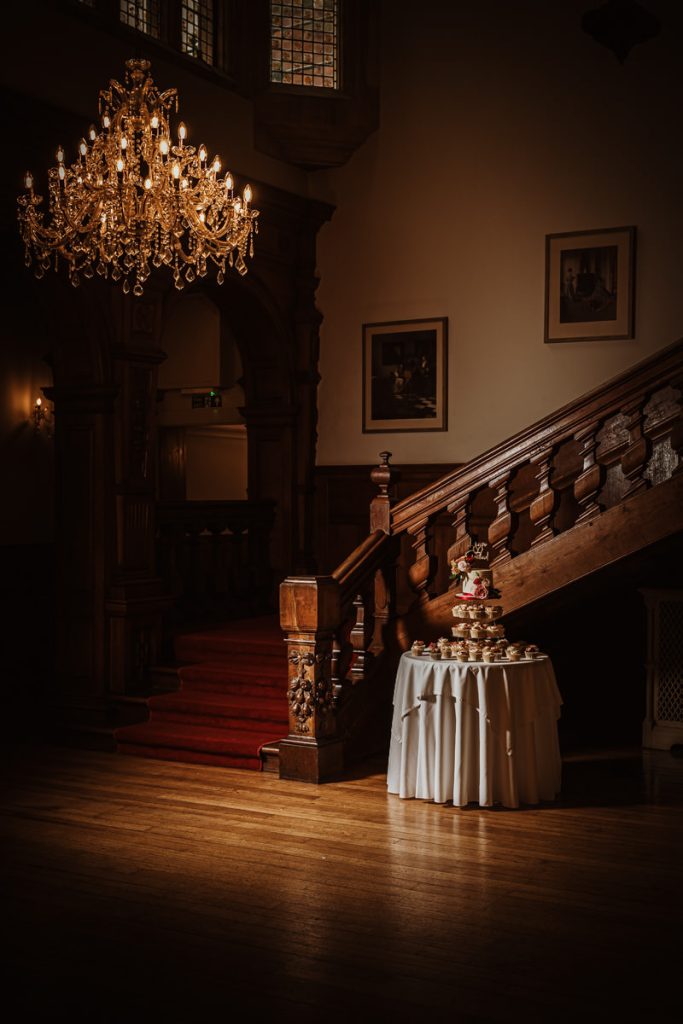Elegant staircase with chandelier and cupcake display