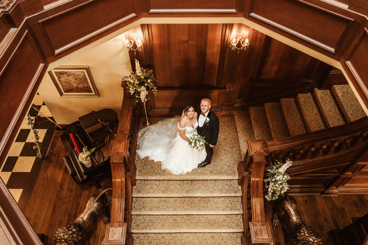 Bride and groom on grand staircase