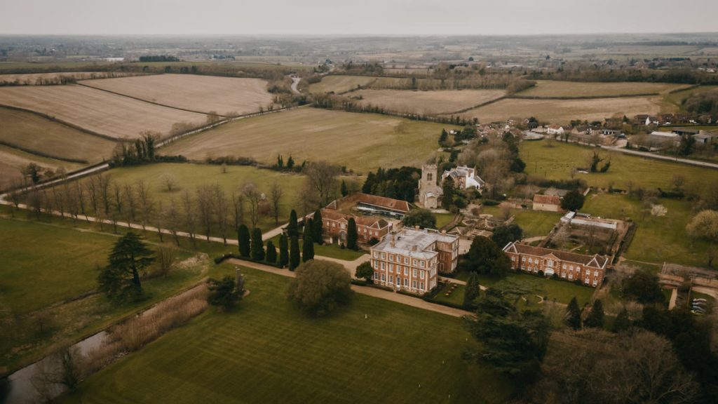 Aerial view of countryside manor and fields in England.