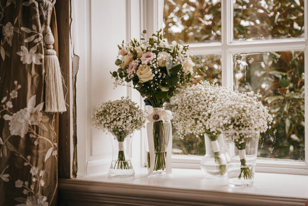 Bouquets of flowers on a windowsill.
