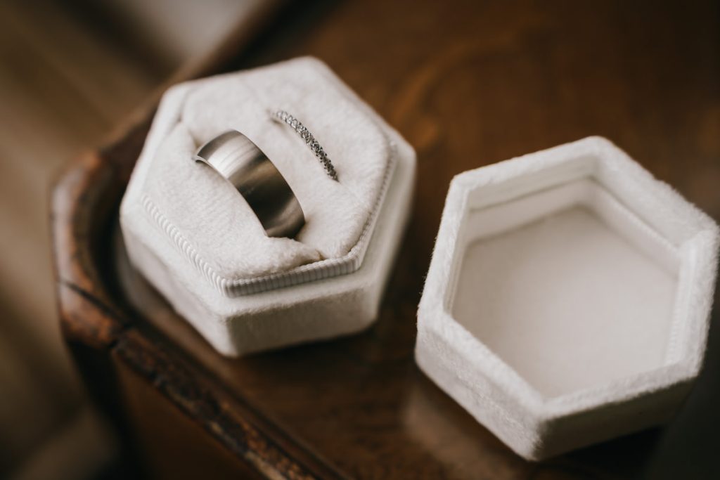 Silver wedding rings in white box on table