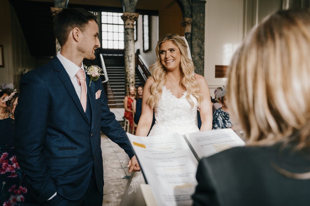 Bride and groom holding hands during ceremony