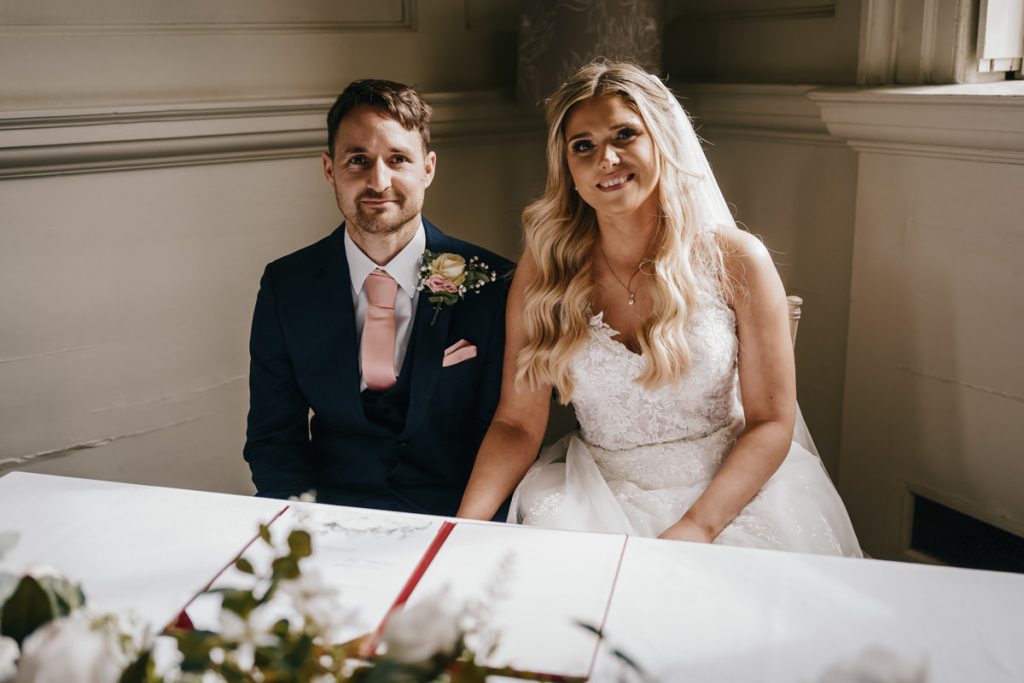 Bride and groom signing wedding documents