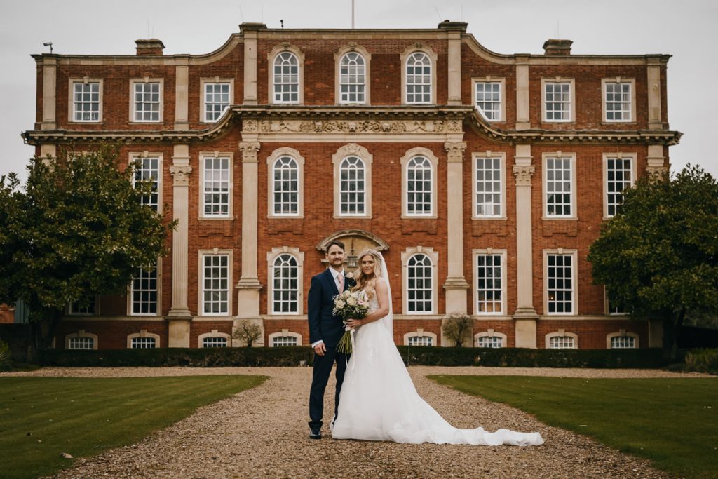 Bride and groom in front of historic mansion