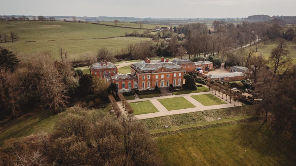 Aerial view of historic red brick mansion.