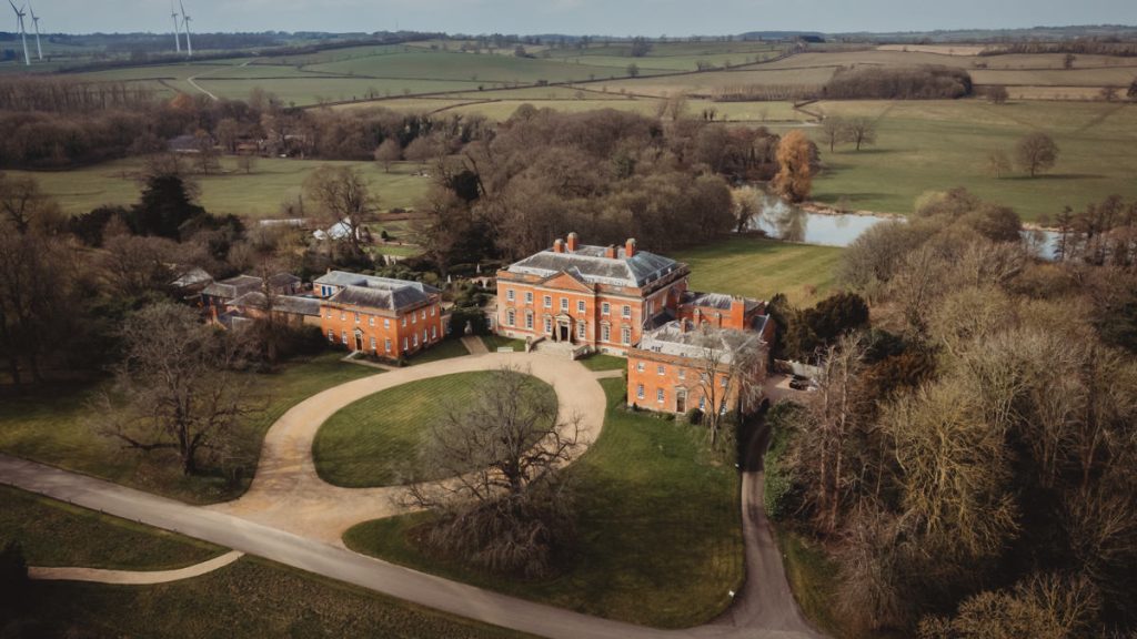 Aerial view of country estate with large mansion.