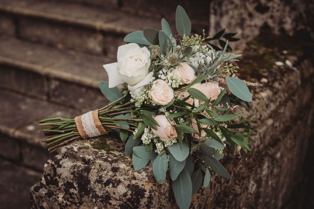 Elegant wedding bouquet on stone steps