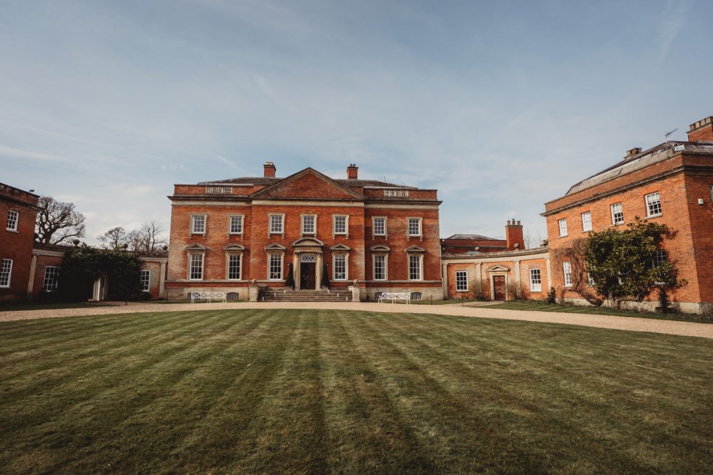 Historic brick mansion with expansive green lawn