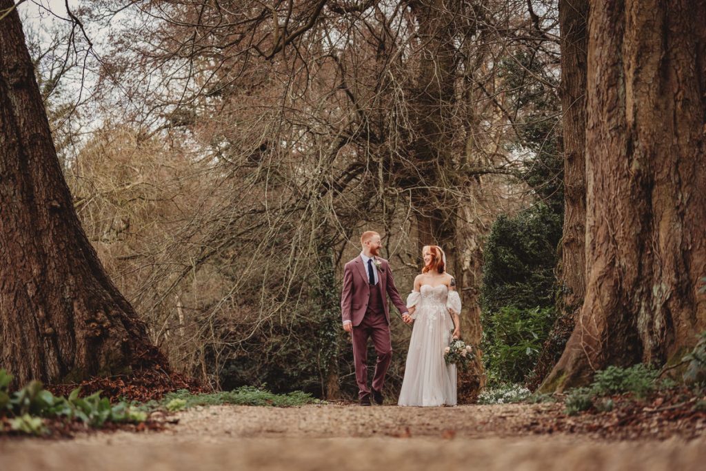Couple walking in forest on wedding day