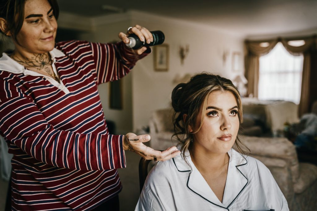 Woman having hair styled with spray at Whittlebury Park