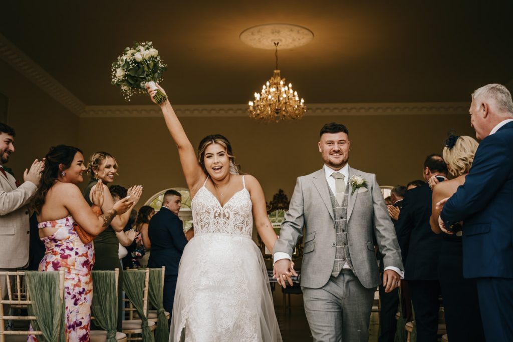 Bride and groom celebrating after wedding ceremony at Whittlebury Park