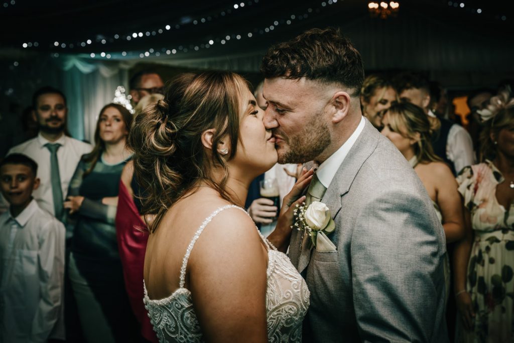 Wedding couple kissing at their reception at Whittlebury Park