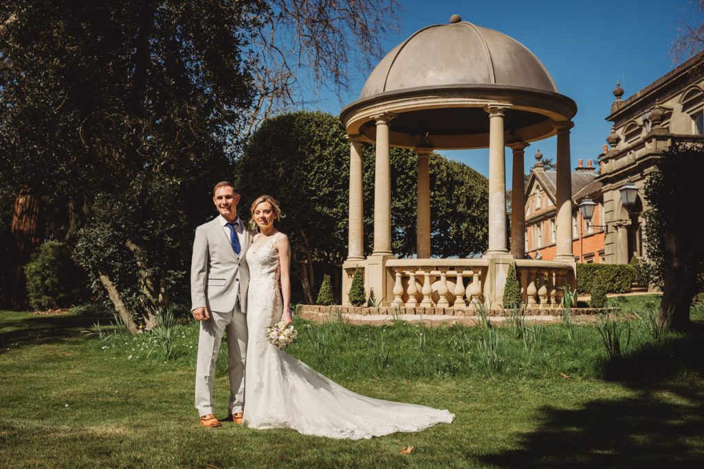Bride and groom by garden gazebo at Kilworth House Hotel