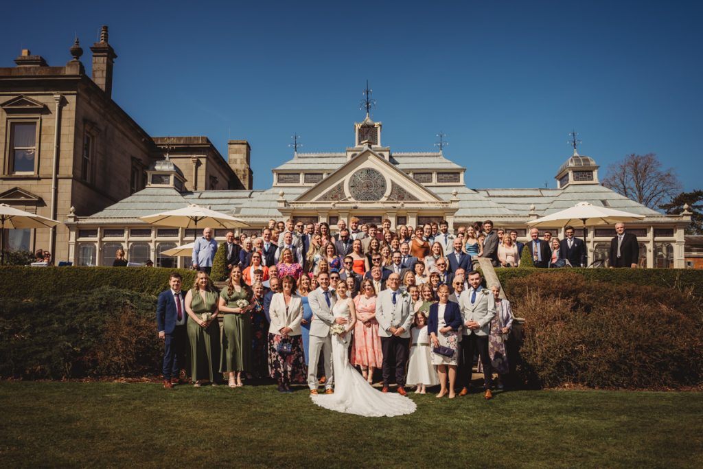 Large wedding group outside stately manor house Kilworth House Hotel