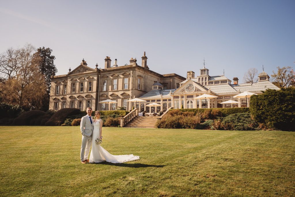 Bride and groom outside historic mansion garden at Kilworth House Hotel