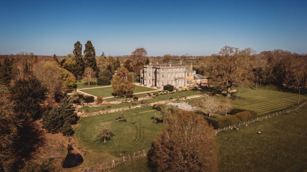 Aerial view of countryside manor and gardens at Bourton Hall by Tom Stenlake Photography