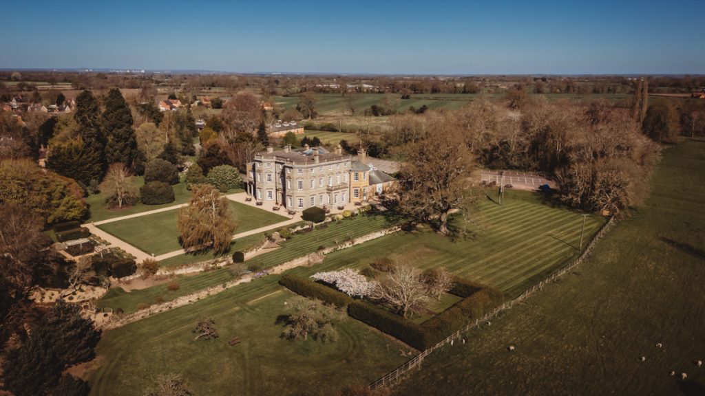 Aerial view of countryside manor and gardens at Bourton Hall by Tom Stenlake Photography