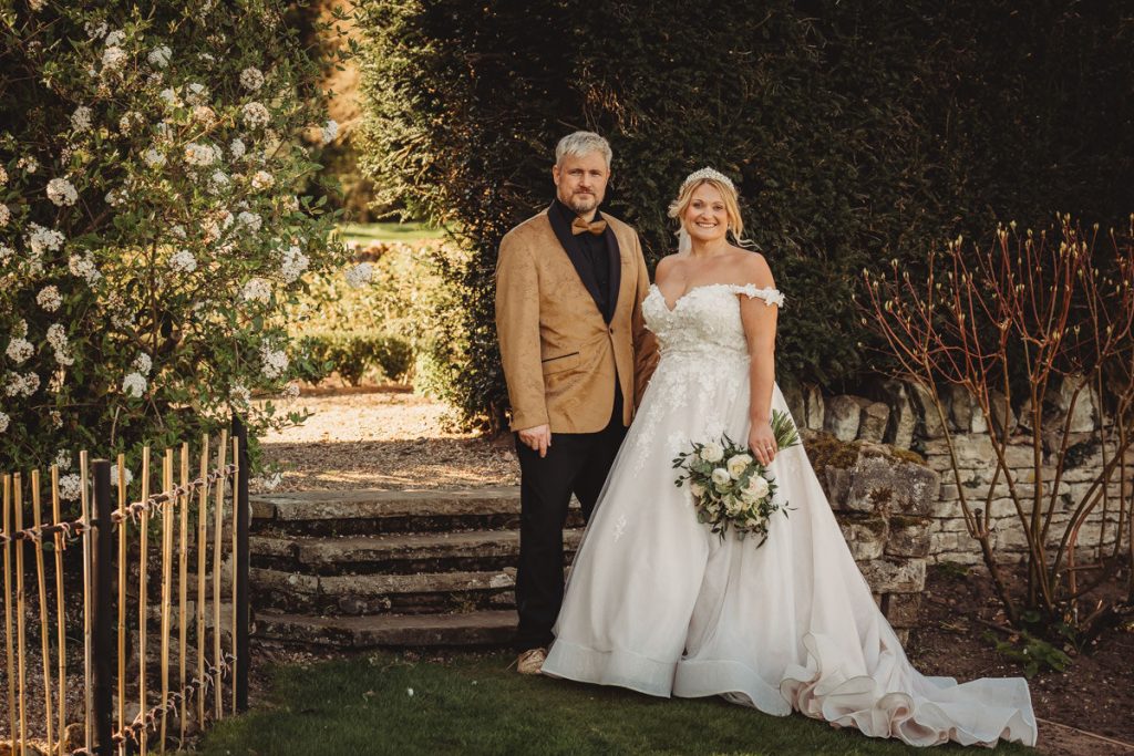 Couple in garden on wedding day at Bourton Hall by Tom Stenlake Photography