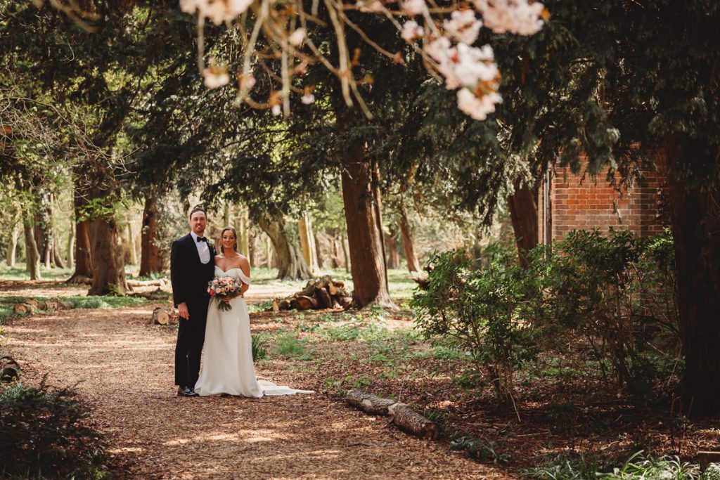 Bride and groom in woodland wedding setting at Chicheley Hall