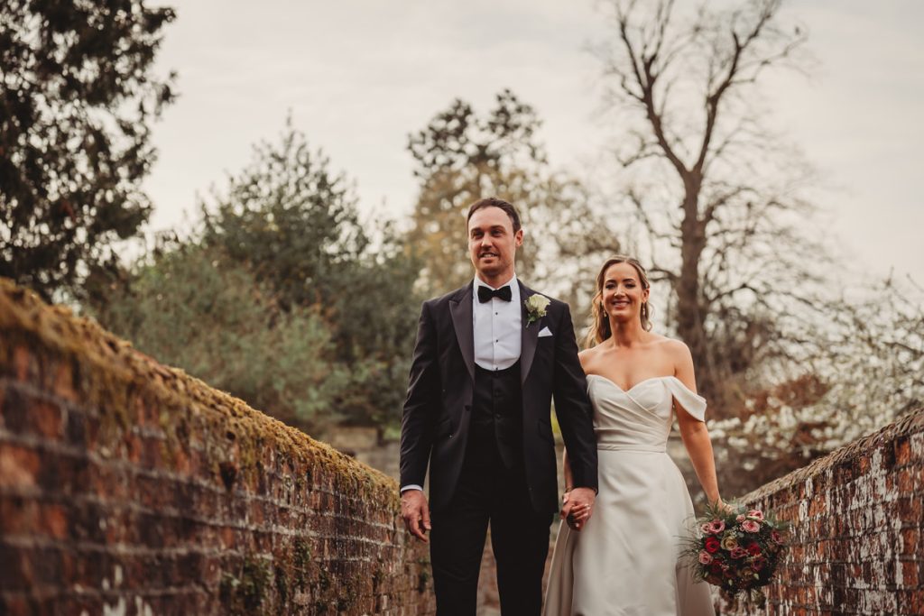 Couple walking outdoors on wedding day at Chicheley Hall
