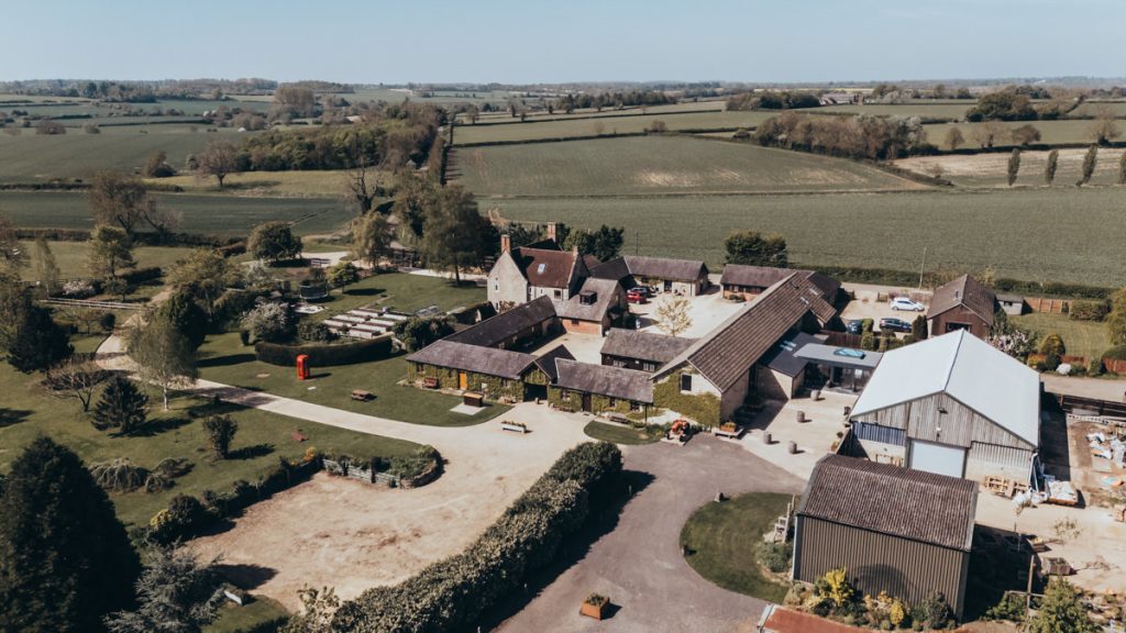 Aerial view of countryside farm buildings and fields at Huntsmill Farm