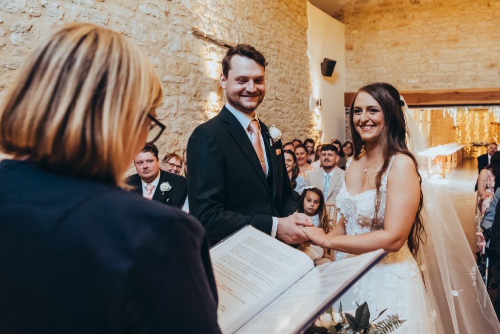 Couple holding hands during wedding ceremony at Huntsmill Farm